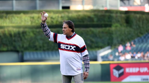 Tony LaRussa waves at the crowd before throwing out first pitch in a Chicago White Sox jersey.
