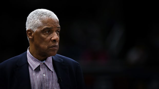 Julius Erving looks on during a basketball game.