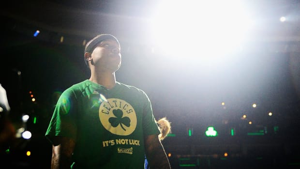 Isaiah Thomas wearing a green celtics t-shirt.