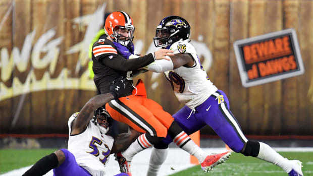 Baker Mayfield #6 of the Cleveland Browns is tackled by Jihad Ward #53 and Matt Judon #99 of the Baltimore Ravens
