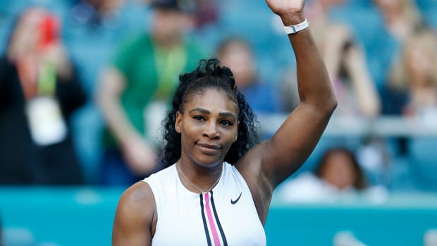 Serena Williams waving to fans.