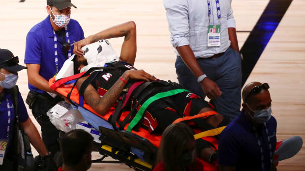 Derrick Jones being taken off on a stretcher.