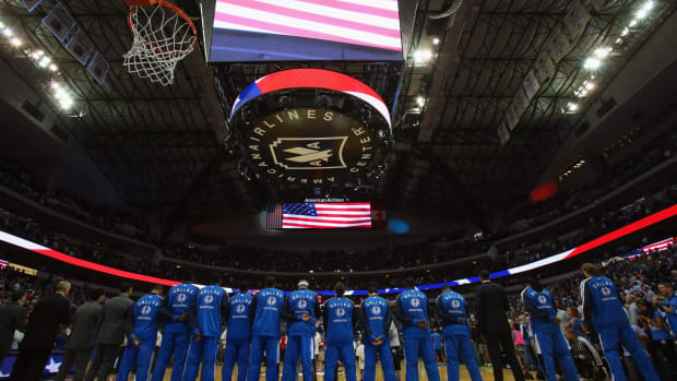 Dallas Mavericks stand for national anthem.