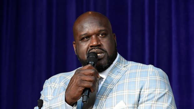 Shaq speaking into a microphone.