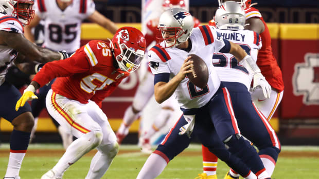 Patriots quarterback Brian Hoyer tries to avoid a sack.