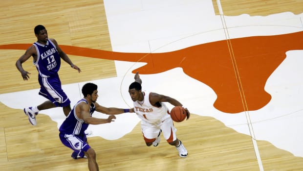 Daniel Gibson dribbling over the Texas Longhorns center court logo.