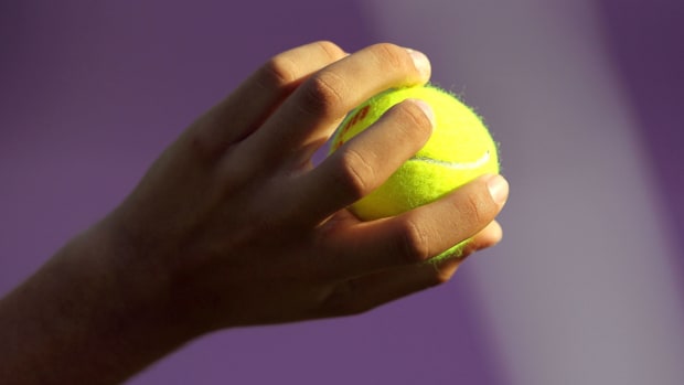 generic picture of someone holding a tennis ball