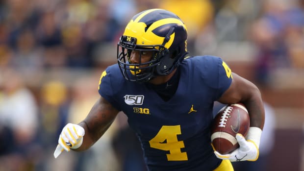 Nico Collins runs with the football for Michigan.