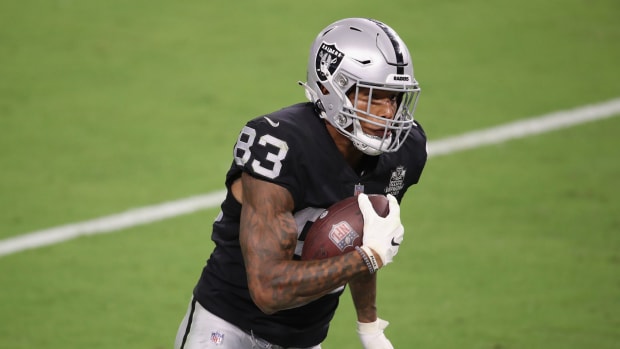 Darren Waller of the Raiders runs with the football.