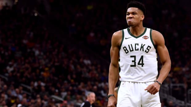 Milwaukee Bucks superstar Giannis Antetokounmpo reacting after dunking the ball during a game.
