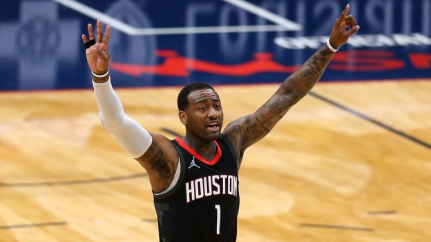 John Wall #1 of the Houston Rockets puts both arms up in the air