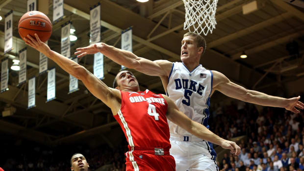 Duke vs. Ohio State college basketball game. Mason Plumlee defends Aaron Craft at the rim.