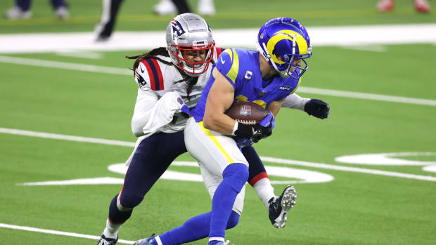 Rams WR Cooper Kupp is tackled by a member of the Patriots.
