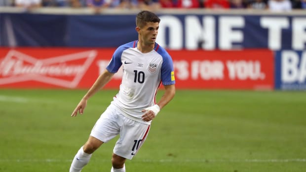 Christian Pulisic dribbling the ball for team USA soccer.
