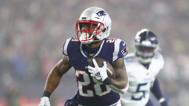 Patriots running back James White carries the ball in a game.