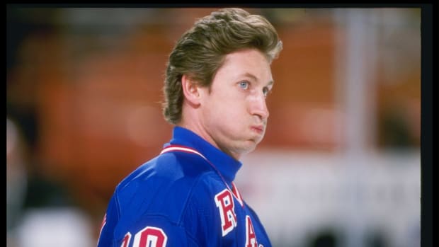 A helmetless Wayne Gretzky on the ice.