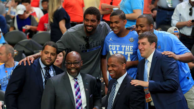 Former UNC players Hubert Davis, Sean May and others pose for picture before a game.