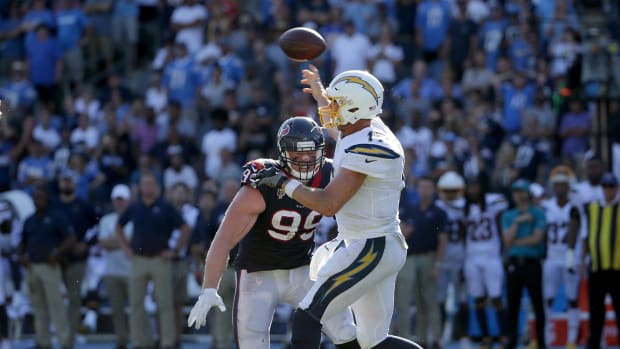 JJ Watt bears down on Philip Rivers, looking for a sack of the Chargers quarterback.