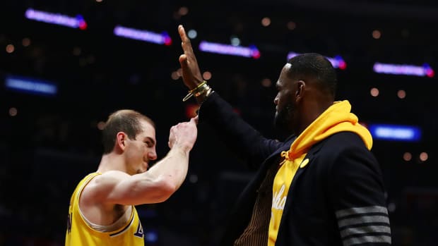 LeBron James high-fives Lakers teammate Alex Caruso.