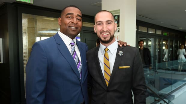 Cris Carter and Nick Wright posing for a photo together.