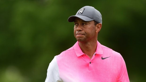 Tiger Woods wearing a pink Nike shirt.