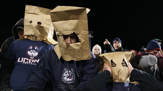 Uconn Huskies football fans with brown paper bags over their heads.