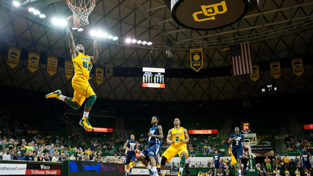 Pierre Jackson making a layup in his yellow Baylor college basketball uniform.