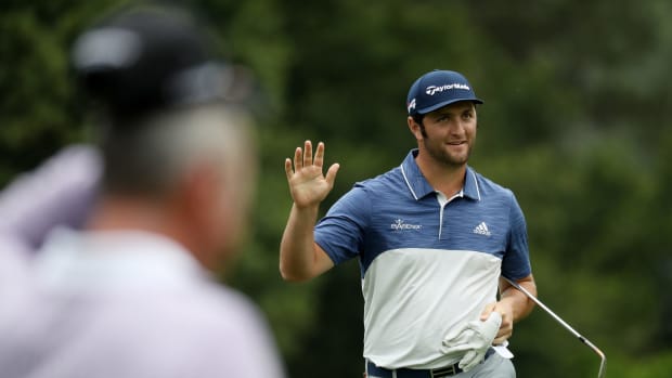Jon Rahm waving to fans at the 2018 Masters.