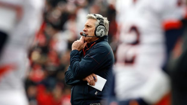 Ron Zook with his hand on his chin while coaching Illinois