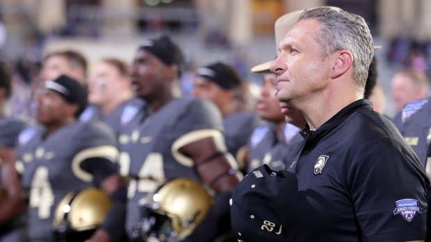 Jeff Monken stands for the Army fight song.