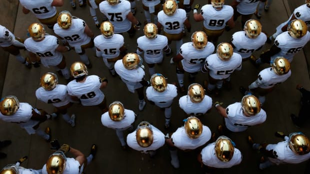 An aerial view of Notre Dame football players walking onto the field.