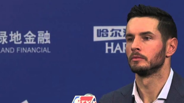 JJ Redick listens at a press conference.