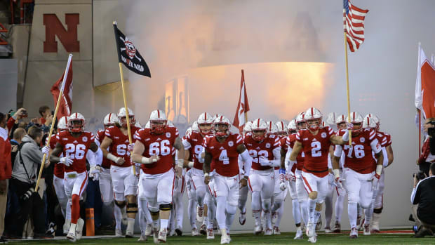 Quarterback Tommy Armstrong Jr. #4 of the Nebraska Cornhuskers leads the team on the field before the game.