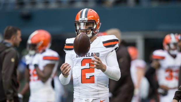 Johnny Manziel spins the football as he warms up for the Browns.