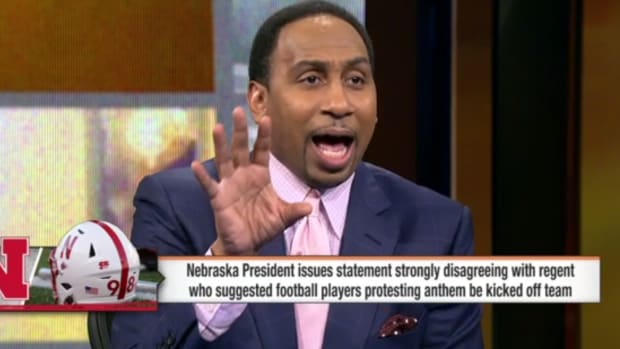 Stephen A. Smith raising his right hand while arguing on ESPN's First Take.
