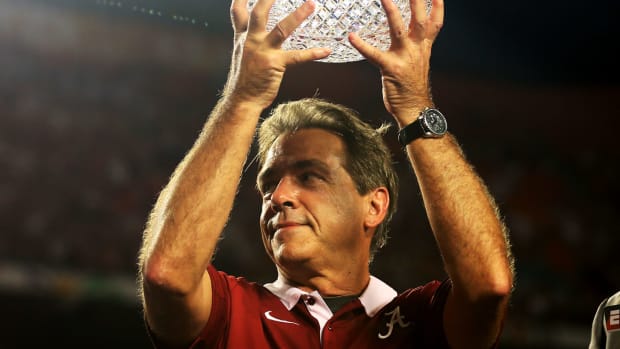Head coach Nick Saban of the Alabama Crimson Tide celebrates with the trophy after defeating the Notre Dame Fighting Irish in the 2013 Discover BCS National Championship game.