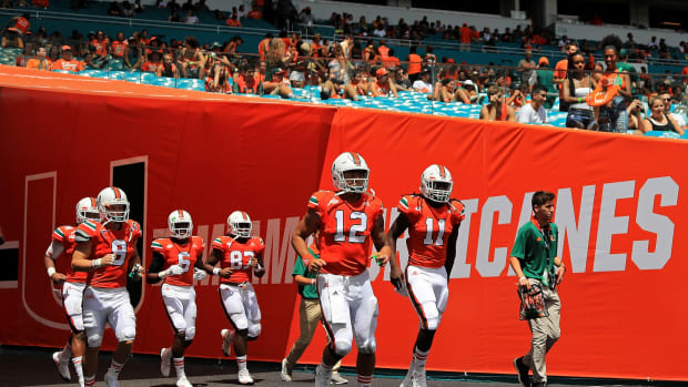 A group of Miami players take the field for a game.