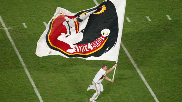 A Florida State Cheerleader running with a flag.