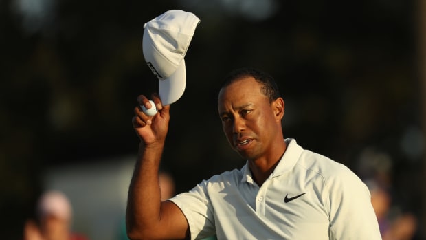 Tiger Woods taking his hat off.