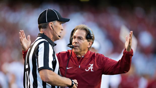Head Coach Nick Saban of the Alabama Crimson Tide argues with a official during a game against the Arkansas Razorbacks.