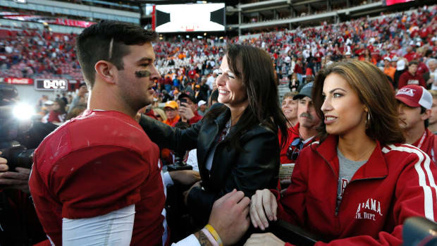 AJ McCarron of the Alabama Crimson Tide celebrates their 45-10 win over the Tennessee Volunteers with mom Dee Dee Bonner and girlfriend Katherine Webb.