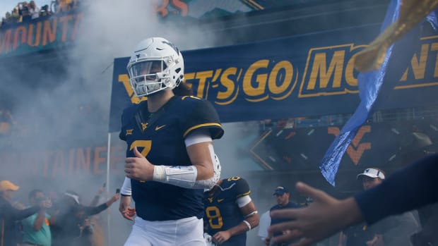 Will Grier of the West Virginia Mountaineers takes the field against the Iowa State Cyclones at Mountaineer Field.