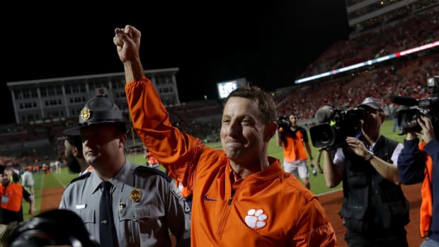 Head coach Dabo Swinney of the Clemson Tigers celebrates after defeating the North Carolina State Wolfpack 38-31 at Carter Finley Stadium.