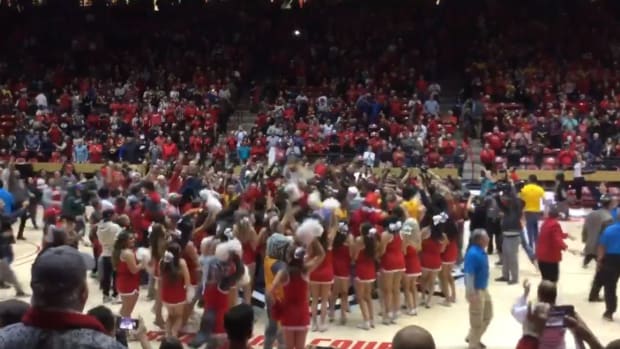 New Mexico fans celebrate on court after handing Nevada basketball its first loss of 2018-19 season.