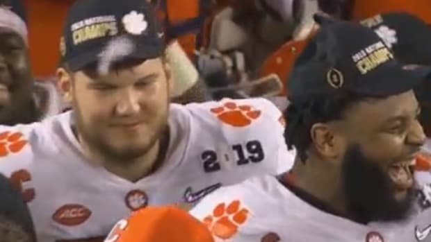Christian Wilkins laughs after giving Dabo Swinney a wet willy.