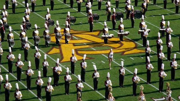 The Arizona State Sun Devils marching band and cheerleaders perform before the college football game against the Arizona Wildcats at Sun Devil Stadium.