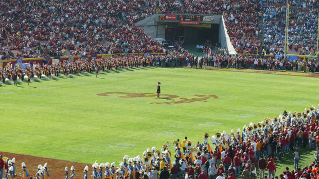 The USC Trojan's mascot standing at the 50 yard line of the team's field.