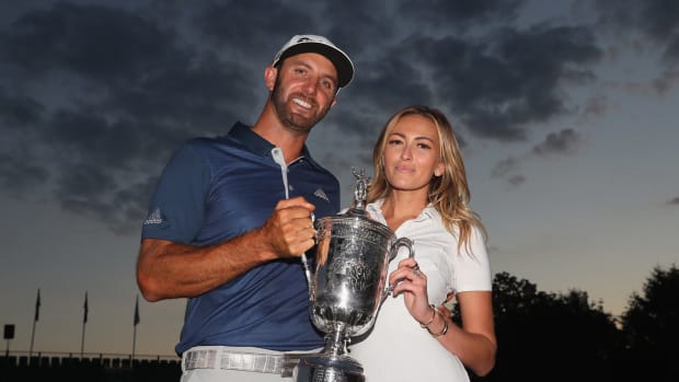 Paulina Gretzky holding a trophy with Dustin Johnson.