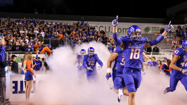 Boise State's football players running onto the field.
