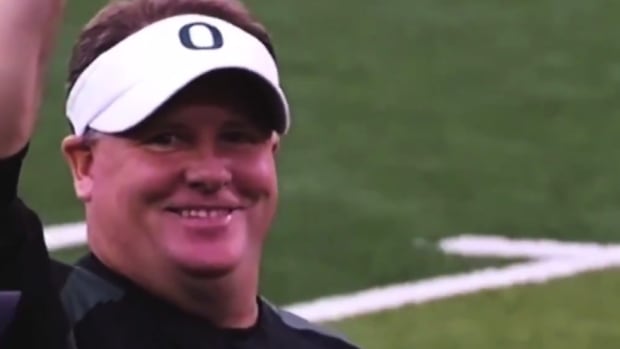 Chip Kelly smiles on the field at Oregon.